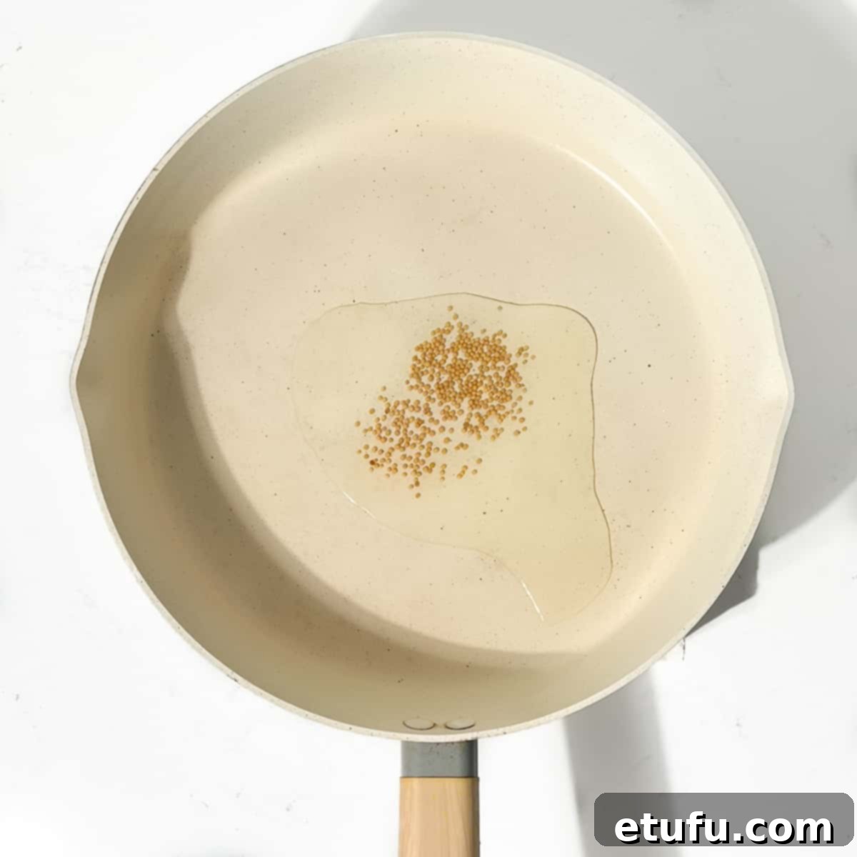 Frying the mustard seeds in hot oil.