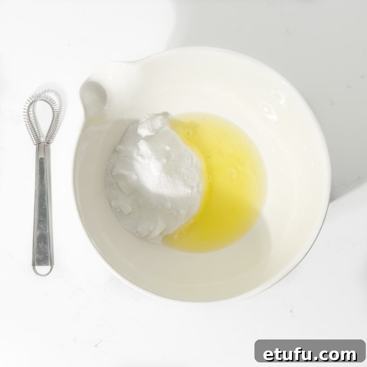 Egg whites and caster sugar combined in a bowl, set over a bain-marie for the Swiss meringue.