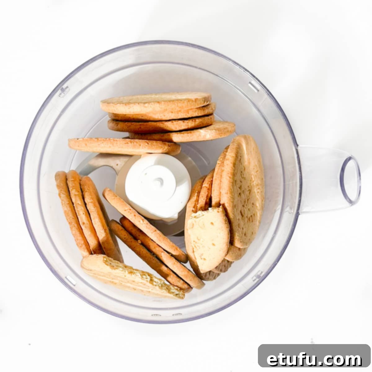Digestive biscuits being crushed in a food processor for the pie crust.