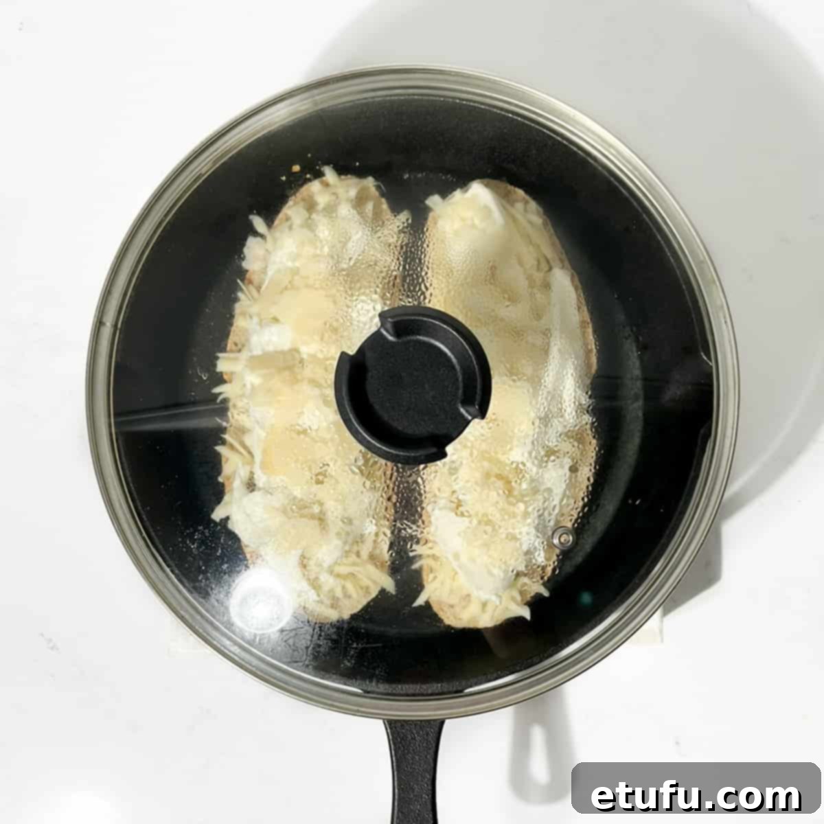 A cast iron pan covered with a lid.