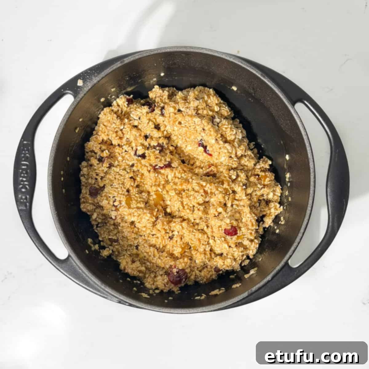 Fruity flapjacks mixture in a large saucepan.