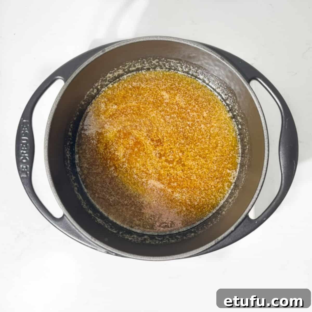 Melted butter and golden syrup in a large baking tin.