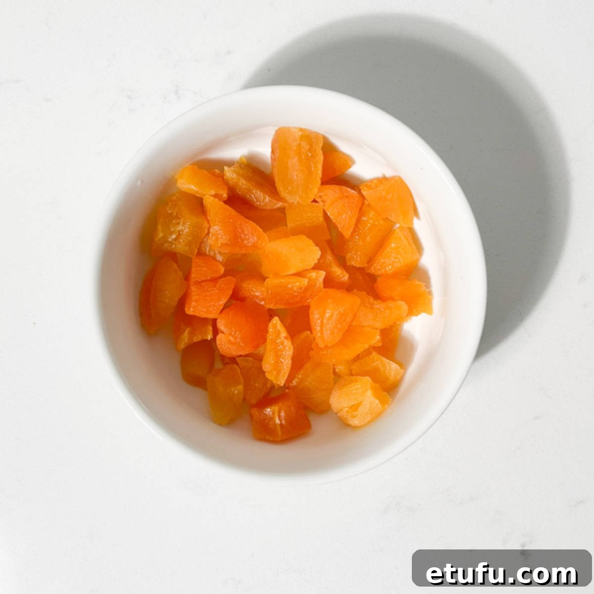 Sliced apricots in a small bowl.