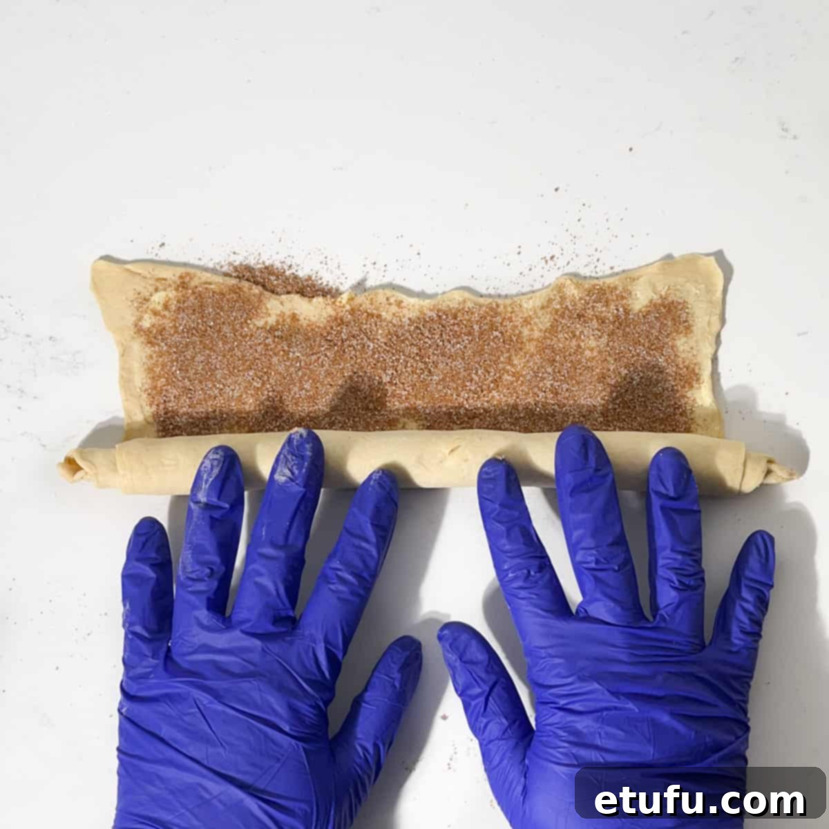 Rolling the dough into a tight sausage.