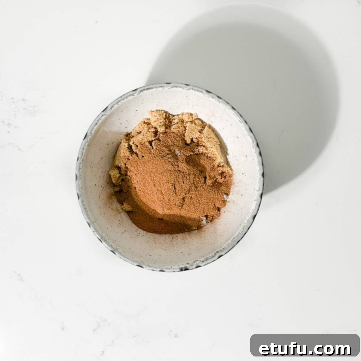 Mixing the white and brown sugar for the cruffins in a bowl.