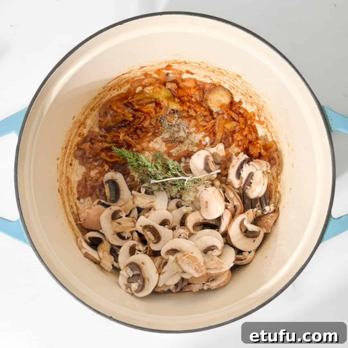 Adding mushrooms, thyme and pepper to onions.