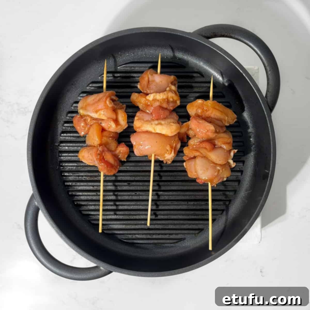 Teriyaki chicken grilling on the griddle.