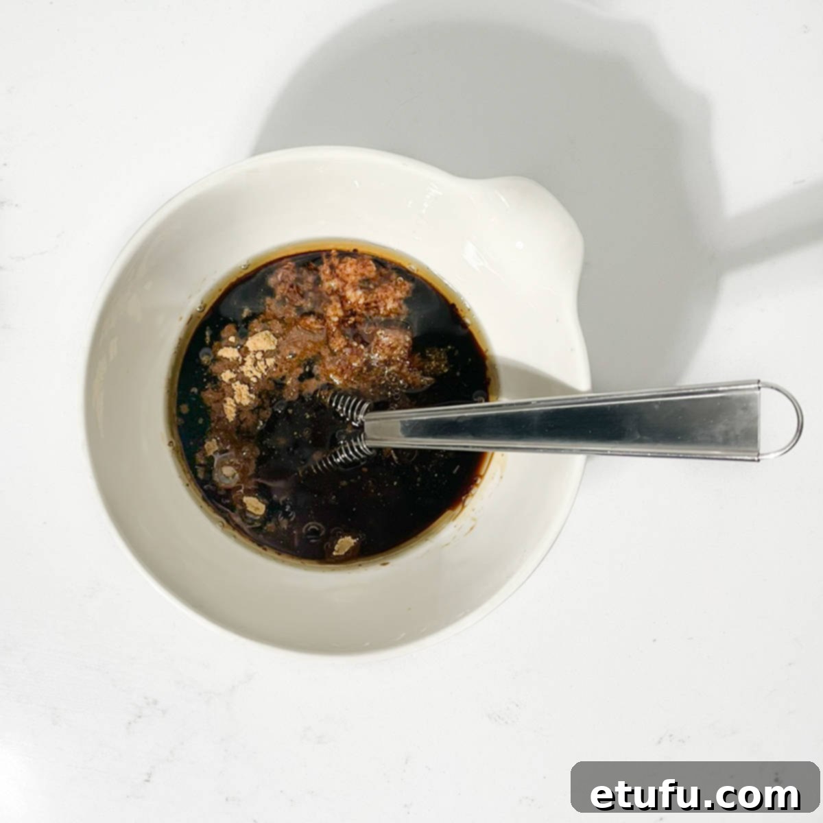 Chinese chicken on a stick marinade in a bowl.