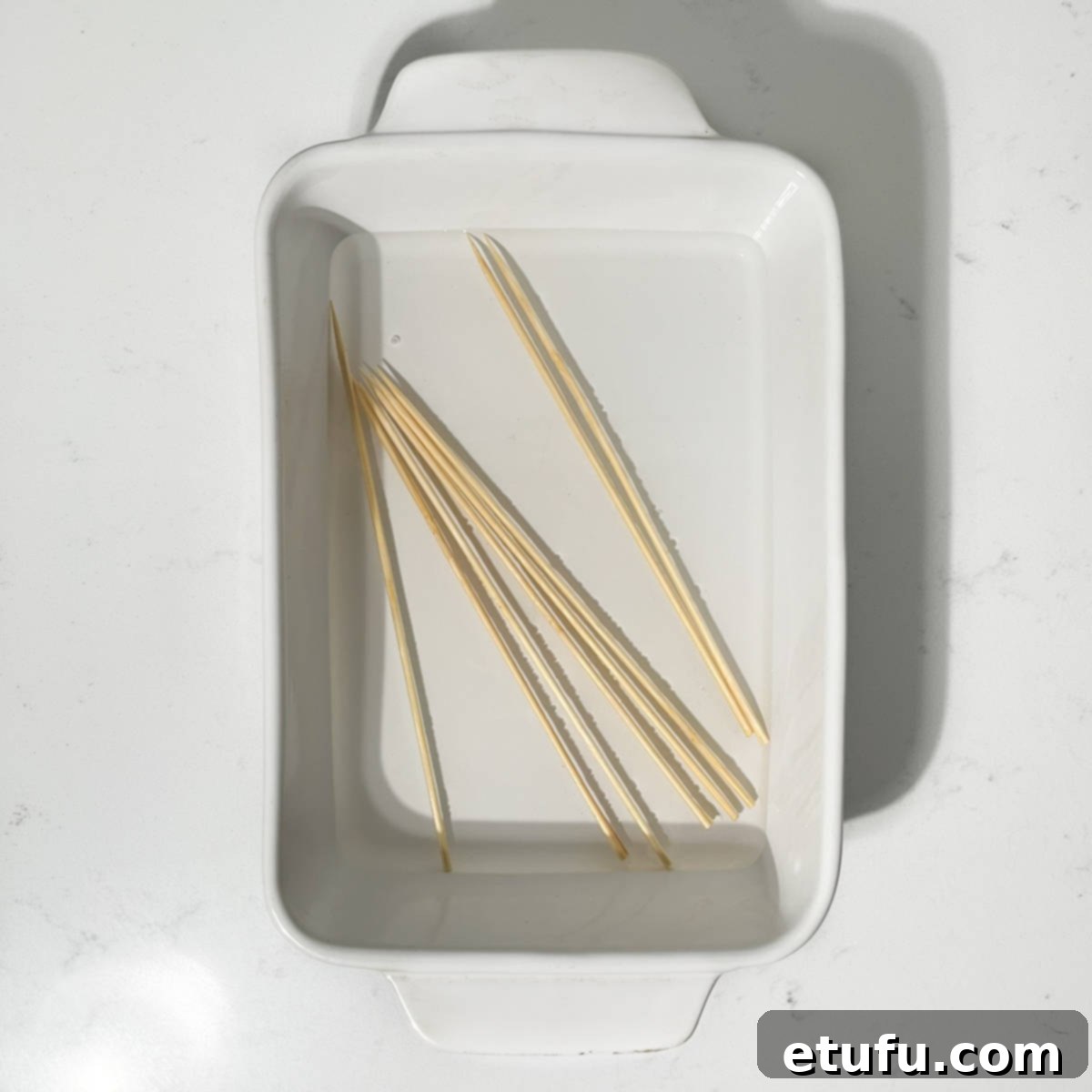 Bamboo skewers soaking in water.