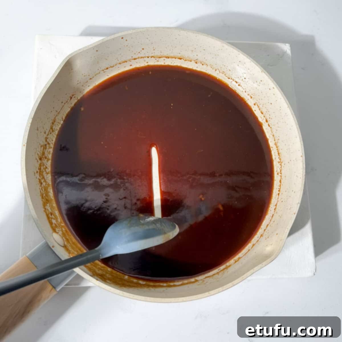 Showing the consistency of the chicken marinade after cooking for a few minutes.