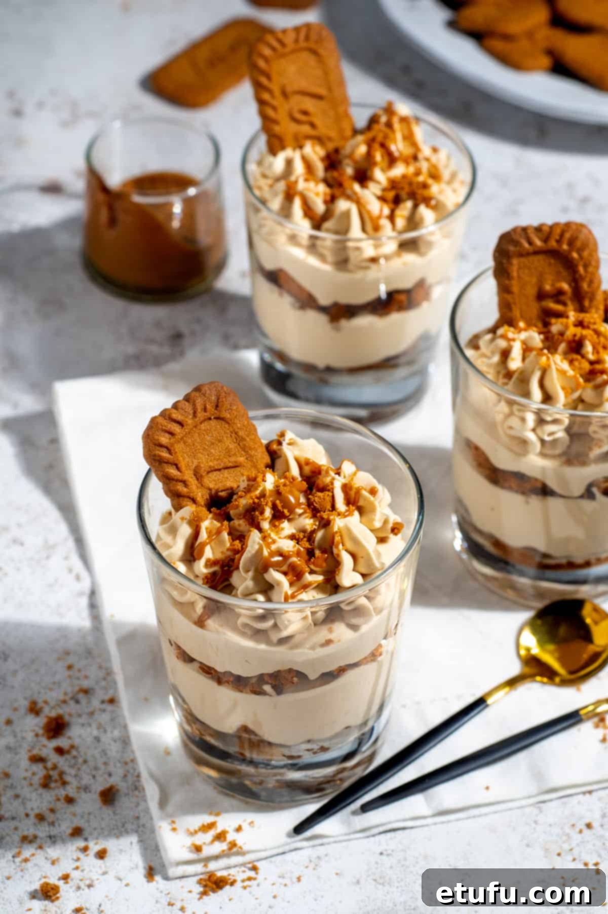 Three glasses of speculoos tiramisu on a white background.
