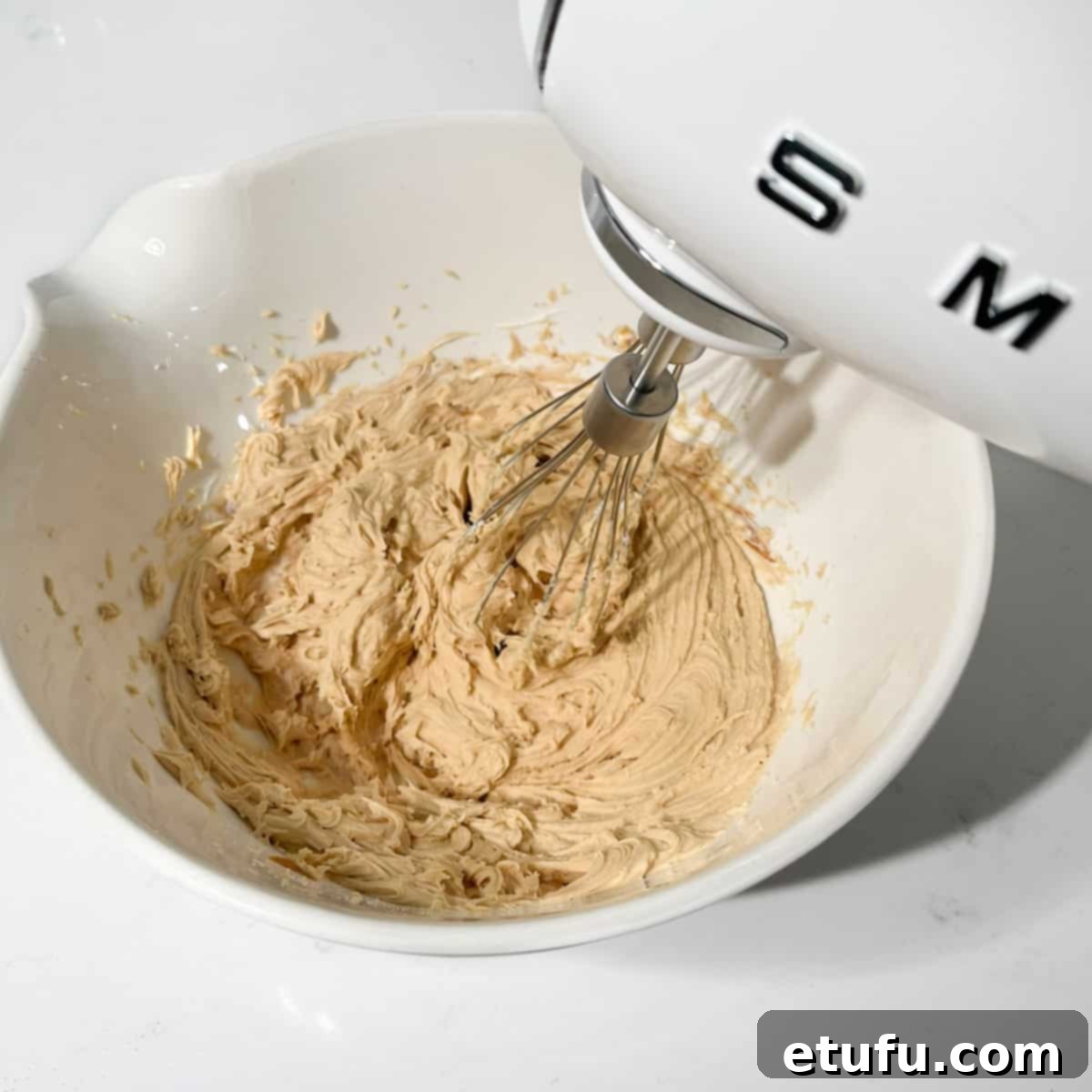 Beating the mascarpone and biscoff spread together.