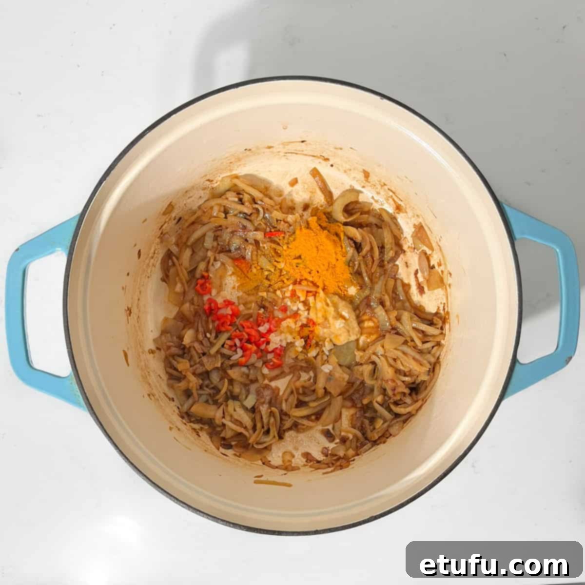 Adding the spices to the onions.