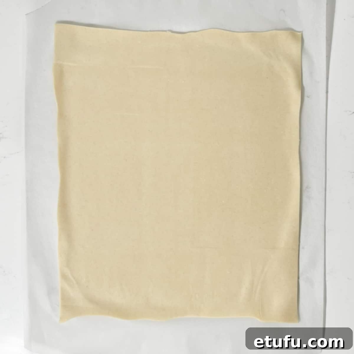 Rolling out the puff pastry for the sausage plait.