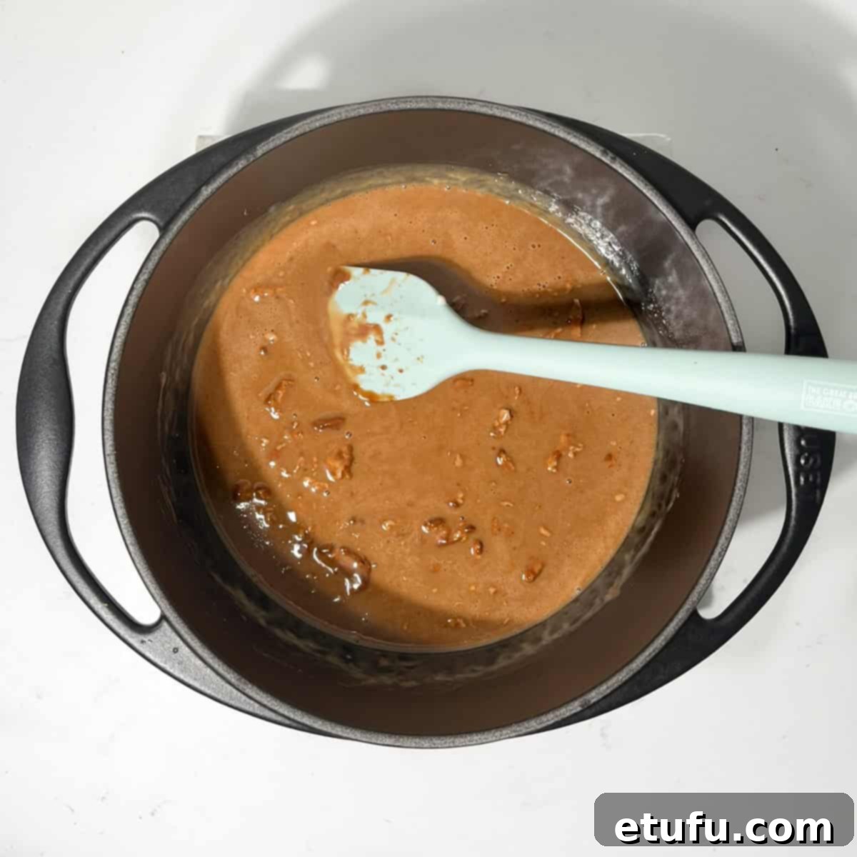 Stirring the Bar-one chunks into the cream as they melt in a small saucepan.