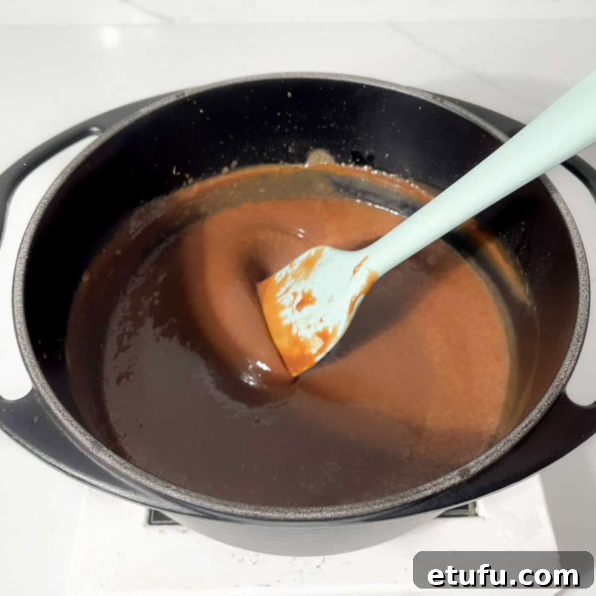 Smooth Bar-one chocolate sauce in a black saucepan after melting and stirring.