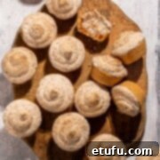 Hertzoggies on a wooden board on a white background.