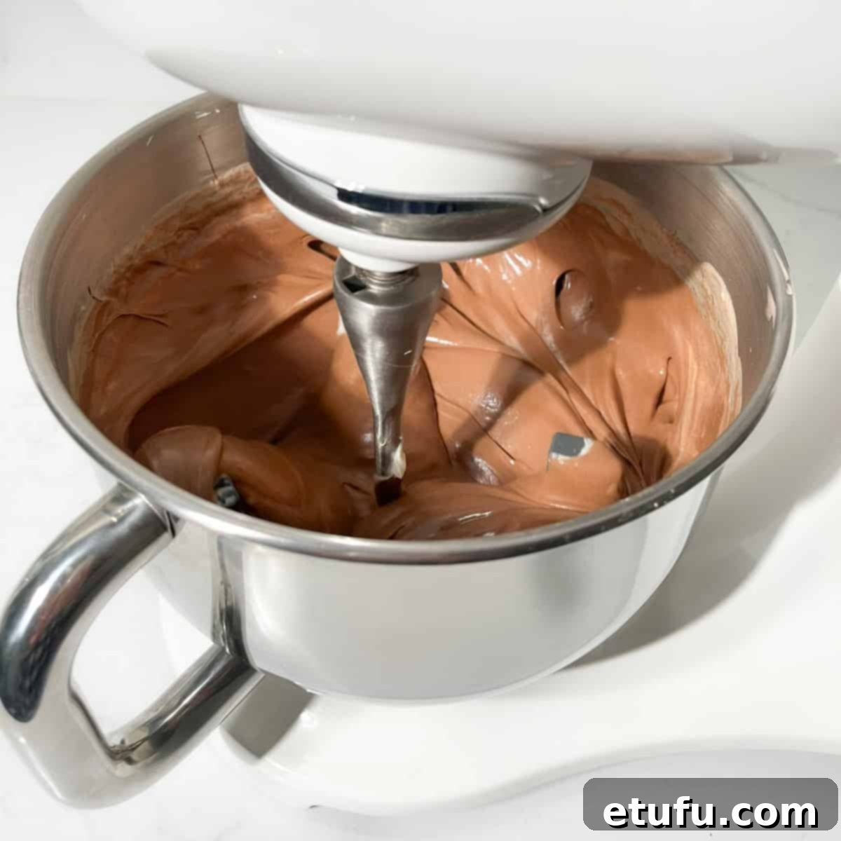 Beating the chocolate basque cheesecake mixture in a stand mixer.