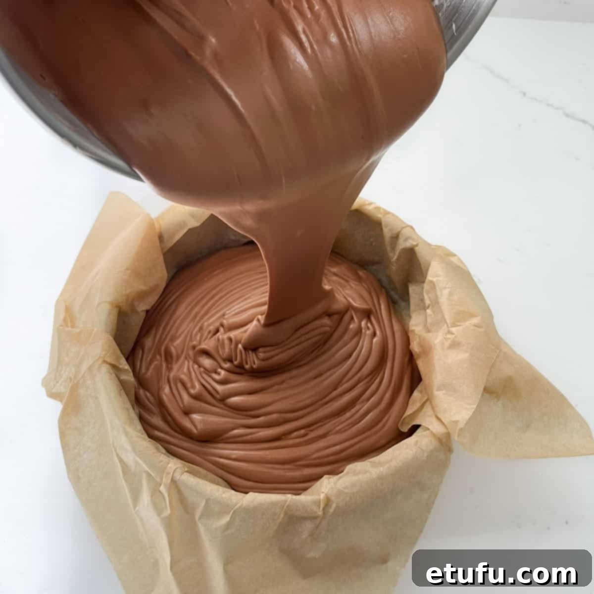 Pouring the chocolate basque cheesecake mixture into the baking tin.
