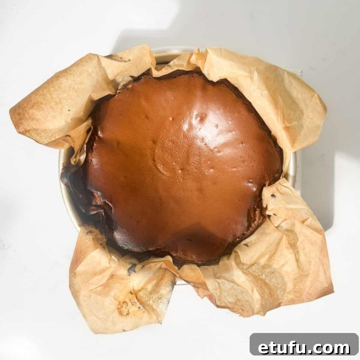 A baked chocolate basque cheesecake in a baking tin.