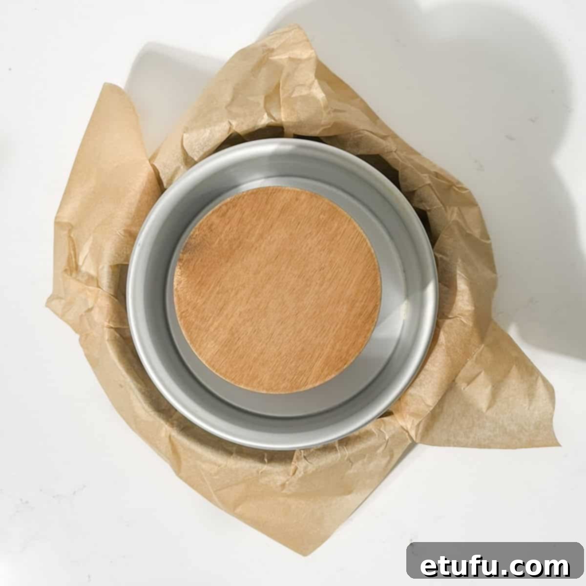 Weighing down the baking paper inside a baking tin with a canister.