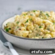 South African potato salad with condensed milk on a white bowl.