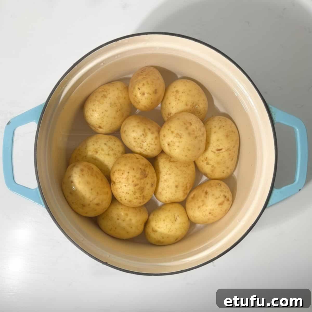 Boiling potatoes in a large saucepan.