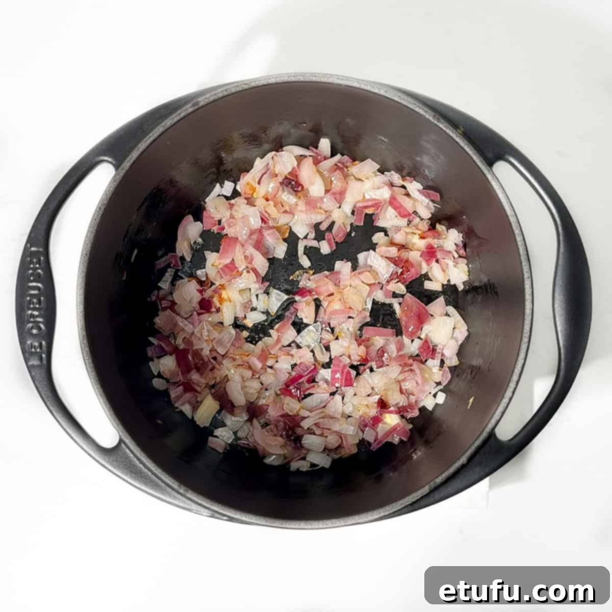 Sultan's Moroccan Pilaf 5 Sautéing finely diced onions in shimmering olive oil in a black cast iron saucepan.