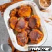 South African Pumpkin Fritters (Pampoenkoekies) with Caramel Sauce in a serving dish.