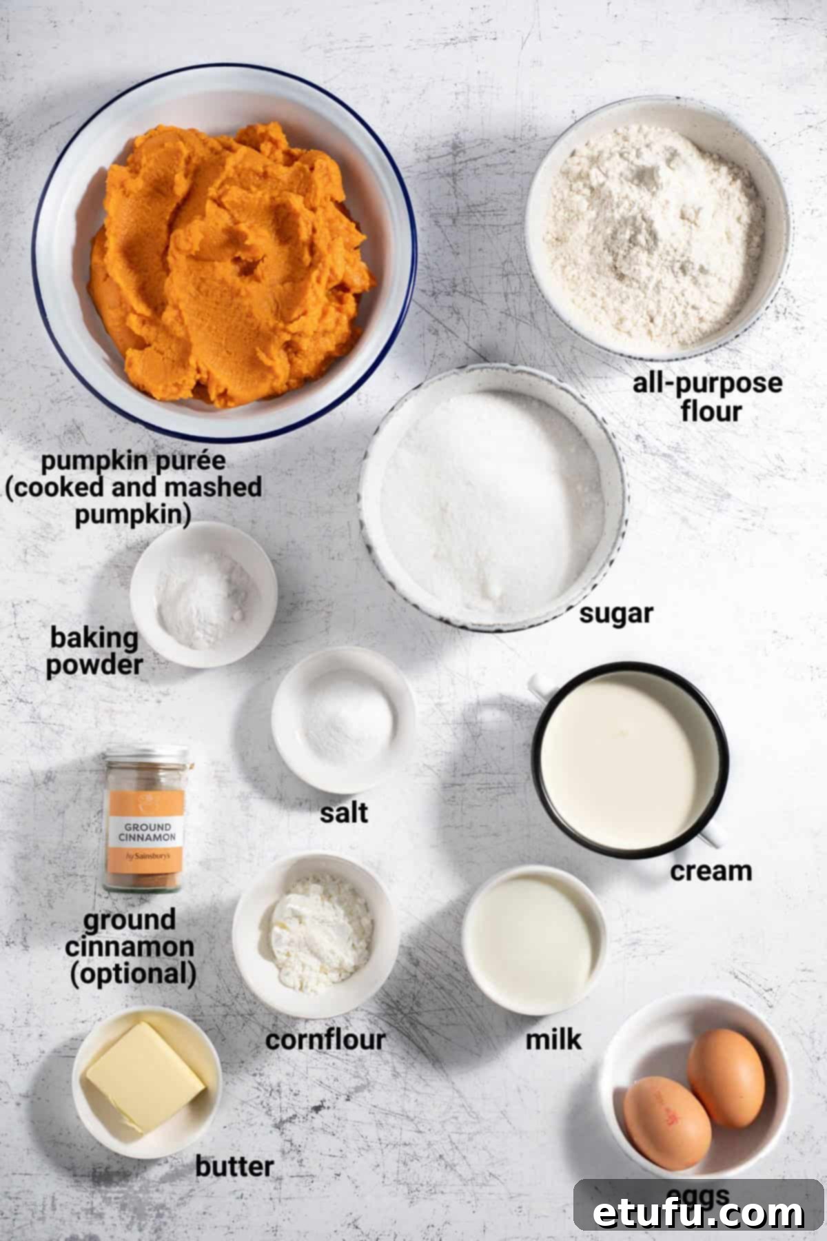 All the essential ingredients for making pampoenkoekies (South African pumpkin fritters) laid out on a kitchen counter, including pumpkin puree, flour, eggs, and spices.
