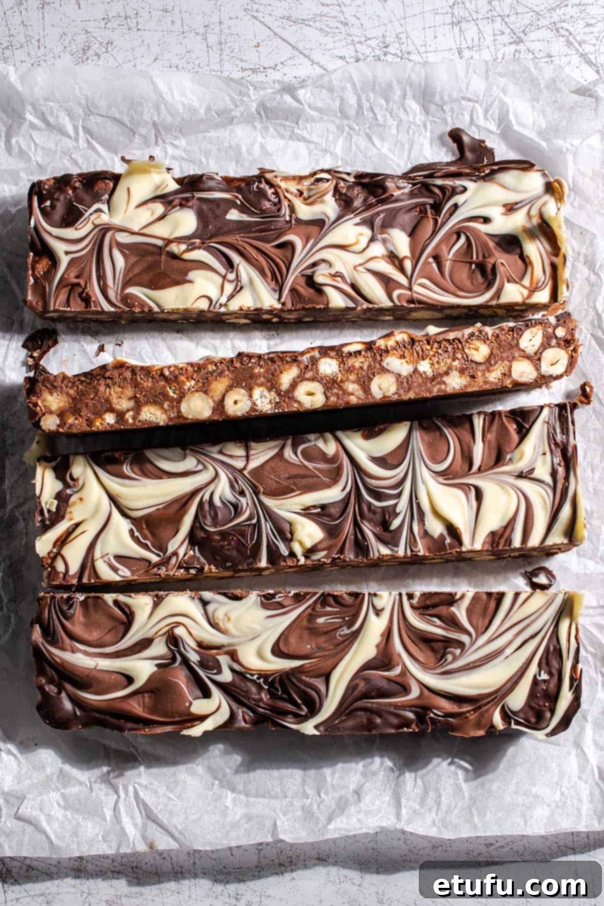 Decadent No-Bake Chocolate Biscuit Delight 2 Slices of chocolate biscuit cake, showcasing its rich texture and marbled topping.