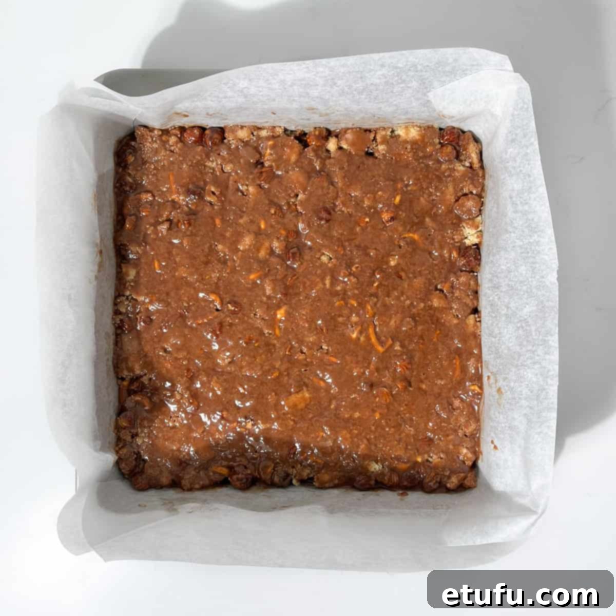 Decadent No-Bake Chocolate Biscuit Delight 10 Chocolate biscuit cake mixture pressed firmly into a square tin.