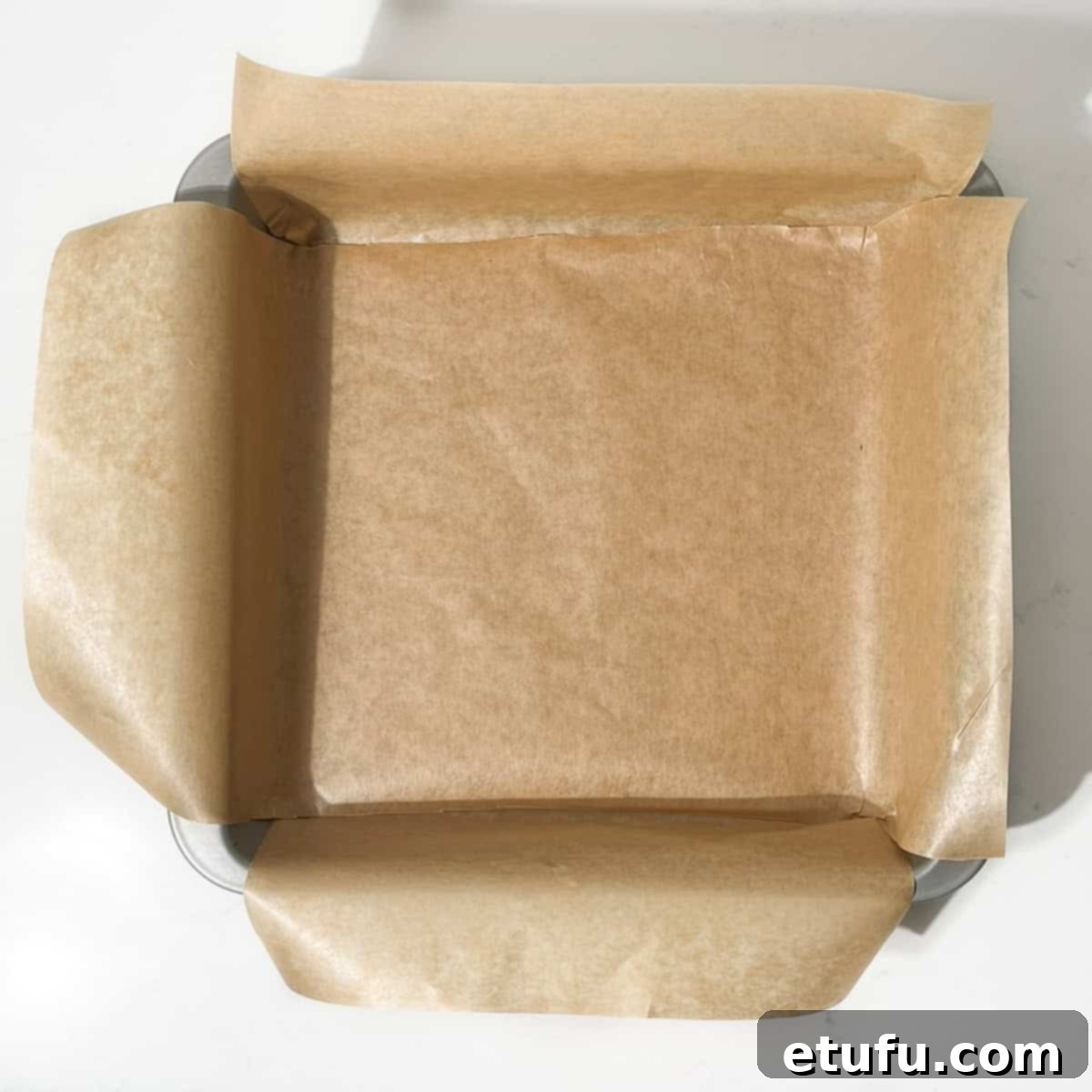 Decadent No-Bake Chocolate Biscuit Delight 4 A lined, square baking tin, ready for the biscuit cake mixture.