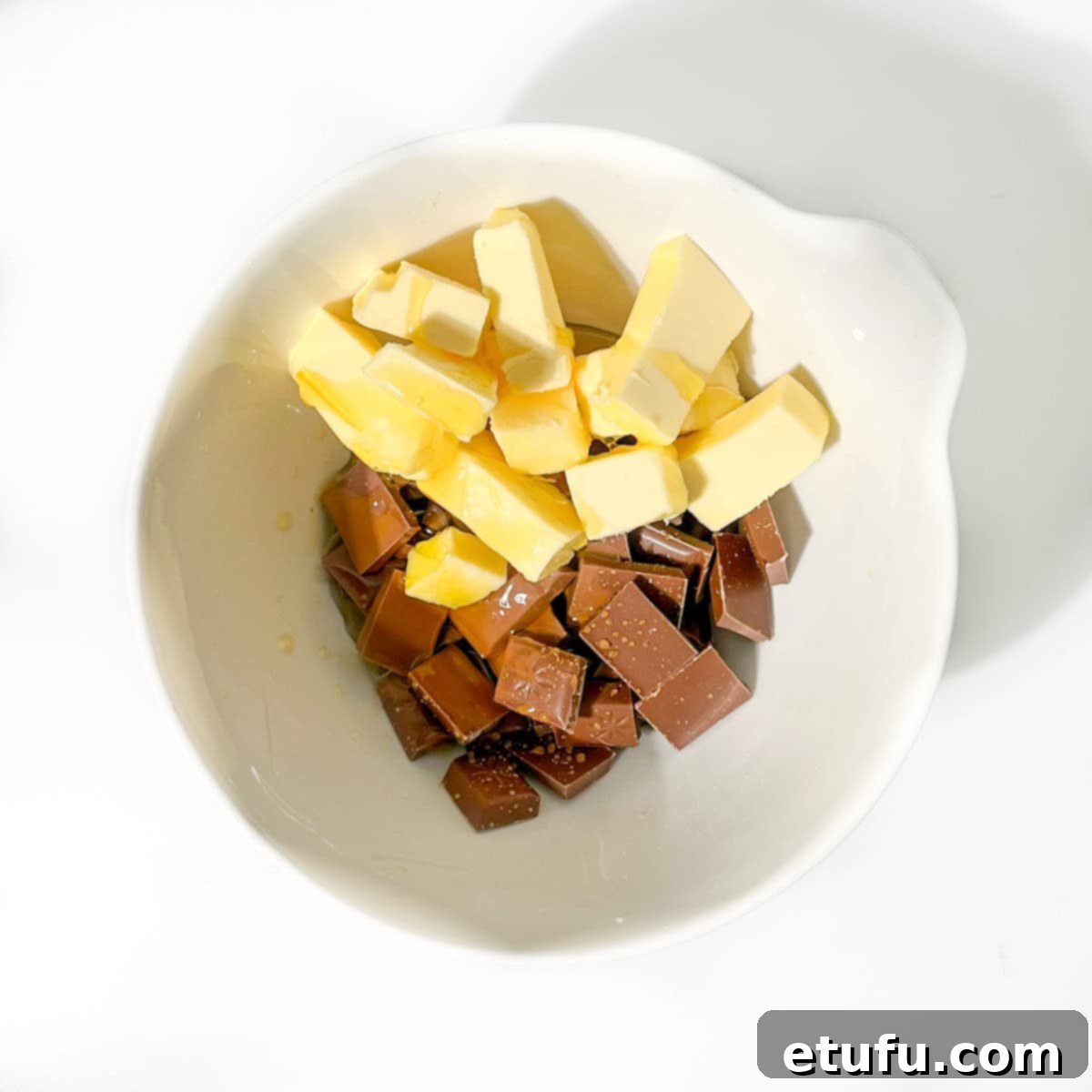 Decadent No-Bake Chocolate Biscuit Delight 5 Adding milk chocolate, golden syrup, and butter to a microwave-safe bowl for melting.